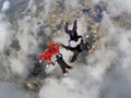 Skydiving 4 way team above the clouds. Royalty Free Stock Photo