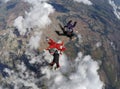 Skydiving 4 way team above the clouds. Royalty Free Stock Photo
