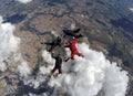 Skydiving 4 way team above the clouds. Royalty Free Stock Photo
