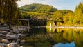 Skykomish River reflecting the railway bridge as the trees begin to turn fall colors Royalty Free Stock Photo