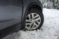 Skykomish, WA USA - circa January 2022: Angled view of a Honda CRV tire stuck in a snow drift during a harsh winter storm in the