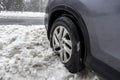 Skykomish, WA USA - circa January 2022: Angled view of a Honda CRV tire stuck in a snow drift during a harsh winter storm in the