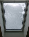 Skylight on a attic covered with snow.