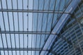 Skylight with rectangular grid pattern over atrium which connect to curvature glass. Royalty Free Stock Photo