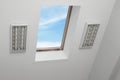 Skylight roof window on slanted ceiling in attic room, low angle view Royalty Free Stock Photo