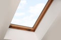 Skylight roof window on slanted ceiling in attic room, low angle view Royalty Free Stock Photo
