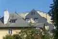 Skylights on roof of multi-storey building. Attics and chimneys in architecture. Selective focus, blur Royalty Free Stock Photo