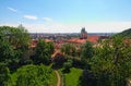 Skyline aerial view of old town Prague, ancient buildings and red tile roofs against blue sky