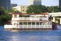 Skyline of Austin, TX, state capitol with Colorado River and riverboat in foreground