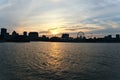 A skyline of city at sunset. Foreground is a river. Montreal downtown, old port, and Saint Laurent river Royalty Free Stock Photo