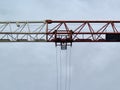 construction crane against soft sky backdrop, industrial tower crane with operator and city skyline Royalty Free Stock Photo