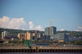 Skyline of Duluth city with modern buildings, port, and a yellow crane against a blue sky