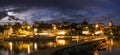 Skyline at night of Murten in Switzerland with the harbor and pier and boat in the foreground Royalty Free Stock Photo