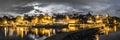 Skyline at night of Murten in Switzerland with the harbor and pier and boat in the foreground Royalty Free Stock Photo