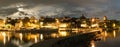 Skyline at night of Murten in Switzerland with the harbor and pier and boat in the foreground