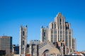 Skyline of the Old Montreal, with the Notre Dame Basilica in front, and a vintage stone Skyscraper in the background Royalty Free Stock Photo