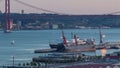 Skyline over Lisbon commercial port day to night timelapse, 25th April Bridge, containers on pier with freight cranes Royalty Free Stock Photo