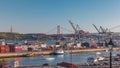 Skyline over Lisbon commercial port timelapse, 25th April Bridge, containers on pier with freight cranes Royalty Free Stock Photo