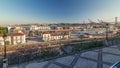 Skyline over Lisbon commercial port timelapse, 25th April Bridge, containers on pier with freight cranes Royalty Free Stock Photo