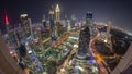 Skyline panorama of the high-rise buildings on Sheikh Zayed Road in Dubai aerial night timelapse, UAE.
