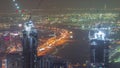 Skyline panoramic view of Dubai Marina showing illuminated skyscrapers and construction site aerial night timelapse Royalty Free Stock Photo