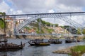 Skyline of Porto from the other side of the river Douro, vila nova de gaia, Dom Luis 1 bridge and wine boats with barrels