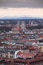 Skyline of city Munich with church St. Maximilian and snow covered Alps in background during sunset, Bavaria
