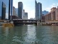 Skyline seen from Chicago river with a train crossing the river on a bridge. Chicago, Illinois, USA. Royalty Free Stock Photo