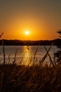 Sail boat shadow with Clear outline of the sun at Sunset with beautiful skyline over lake Zorinsky Omaha Nebraska Royalty Free Stock Photo