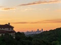 Skyline shot of Austin Texas downtown nestled between hills during vibrant golden sunrise