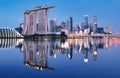 Skyline of Singapore Marina Bay at night with Marina Bay sands, Art Science museum and tourist boats Royalty Free Stock Photo