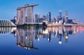 Skyline of Singapore Marina Bay at night with Marina Bay sands, Art Science museum and tourist boats