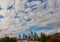 Skyline with the skyscrapers of Frankfurt and the river Main in the foreground with big cloudy blue and white sky Royalty Free Stock Photo