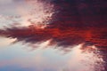 Skyline of sun rays through fiery red clouds on the sunset. Royalty Free Stock Photo