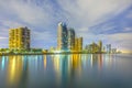 Skyline of Sunny Isles Beach by night with reflections at the surface of the ocean Royalty Free Stock Photo