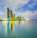 Skyline of Sunny Isles Beach by night with reflections at the surface of the ocean Royalty Free Stock Photo