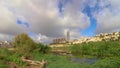 Skyline timelaps over the gazelle park lake, in the background of the tall buildings of the Holyland neighborhood