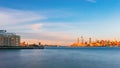 Skyline of uptown Manhattan over Hudson River under blue sky, at