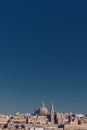 Skyline of Valletta, Malta under blue sky, with dome of Basilica of Our Lady of Mount Carmel and tower of St Paul`s Pro-Cathedral