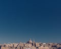 Skyline of Valletta, Malta under blue sky, with dome of Basilica of Our Lady of Mount Carmel and tower of St Paul`s Pro-Cathedral