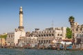 Skyline view of Dubai Creek with traditional boats and piers, United Arab Emirates