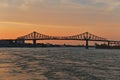 A skyline view a steel bridge across at sunset. Jacques Cartier Bridge across Saint Laurent river, Montreal, Quebec, Canada