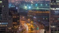 Skyline view of traffic on Al Saada street near DIFC district night to day timelapse in Dubai, UAE. Royalty Free Stock Photo