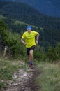 Skyrunner runs uphill along a mountain ridge. Front view, caucasian man. Sunny summer day.slovakia, tatras, Europe.
