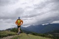 Skyrunner runs uphill along a mountain ridge. Front view, caucasian man. Sunny summer day.slovakia, tatras, Europe. Royalty Free Stock Photo