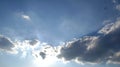 Skyscape: altocumulus in front of the sun and a tiny glider with blue in background Royalty Free Stock Photo