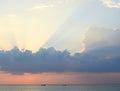 Skyscape at time of Sunset - Bright Golden Sunrays spreading through Clouds with Orange sky at Horizon over Blue Sea Water Royalty Free Stock Photo