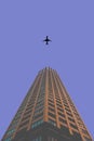 Skyscraper airplane fly over big office building under clear blue sky Royalty Free Stock Photo