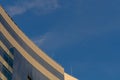 Skyscraper on the background of almost clear blue sky, round building design