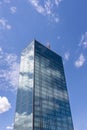 Skyscraper in business district against blue sky. Modern corporate building and architecture Royalty Free Stock Photo